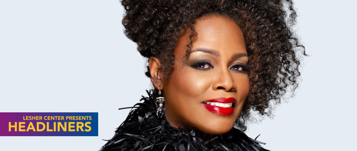 Close-up photo of a Black woman's face with her curly hair pinned up.